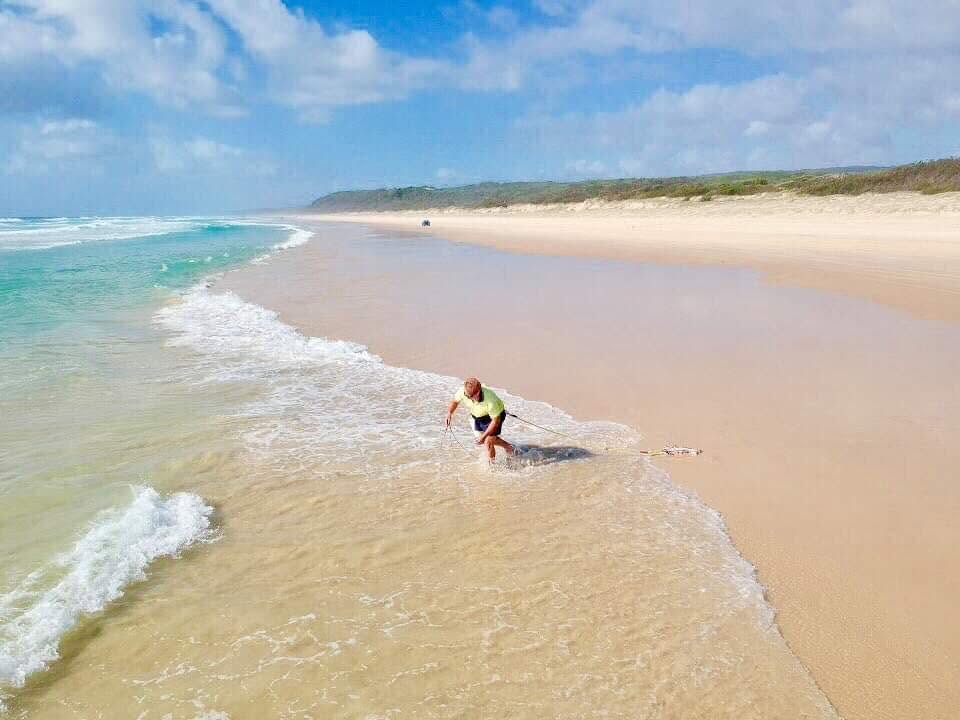 Drew on Rainbow Beach catching some worms